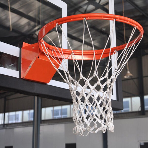 Orange basketball hoop with white net mounted to a backboard in an indoor gym facility.
