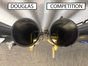 Newsfeed-Premier-XS-Comparison-3 - Douglas Sports Equipment Top-down view of two cylindrical tubes labeled DOUGLAS (left) and COMPETITION (right), with dark bore interiors and gold mounting hardware visible at the base.